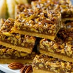 A serving platter full of pecan pie bars.