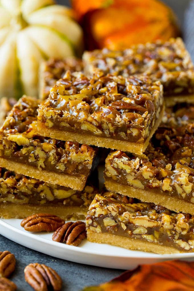 A serving platter full of pecan pie bars.