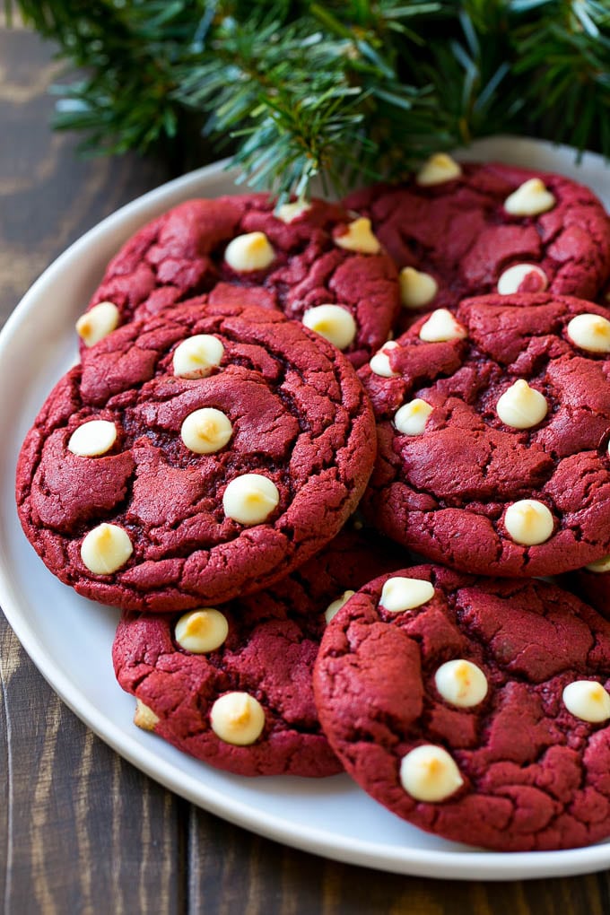 Red Velvet Cookies on a serving plate with holiday decorations nearby,