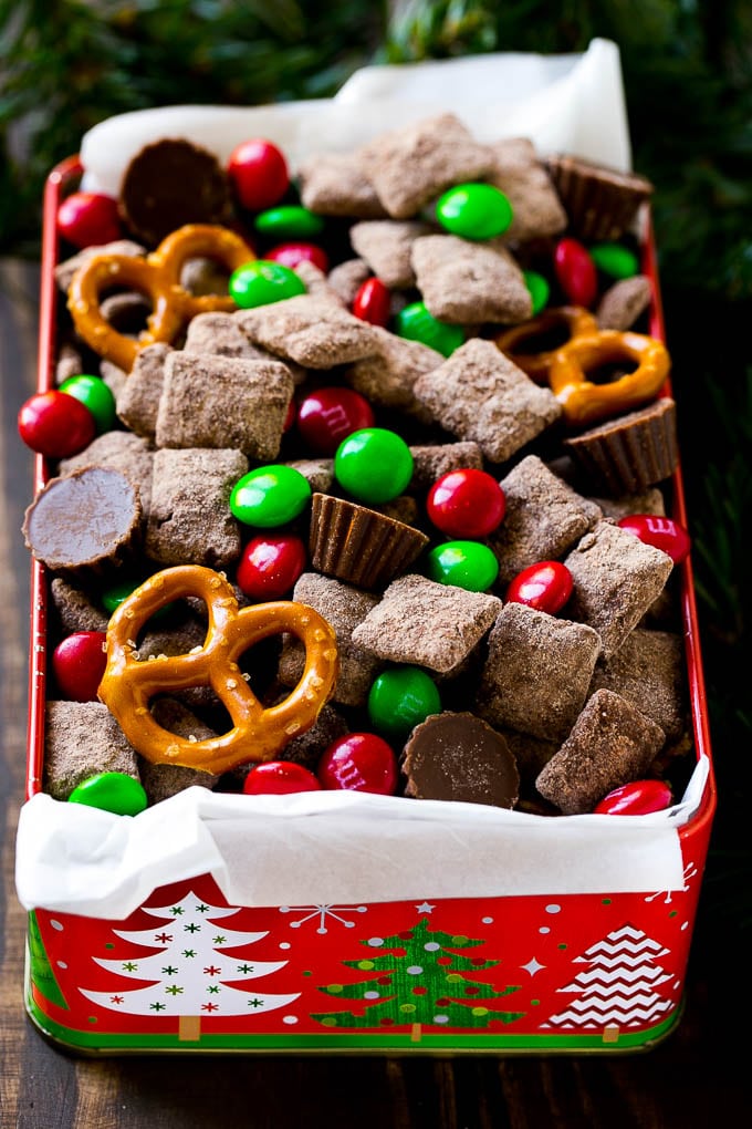 A tin filled with reindeer chow snack mix.