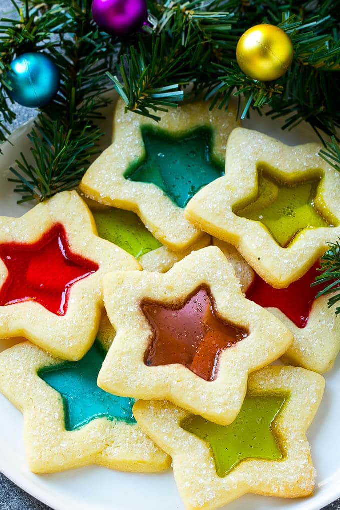 A plate of star shaped stained glass cookies with colorful centers.