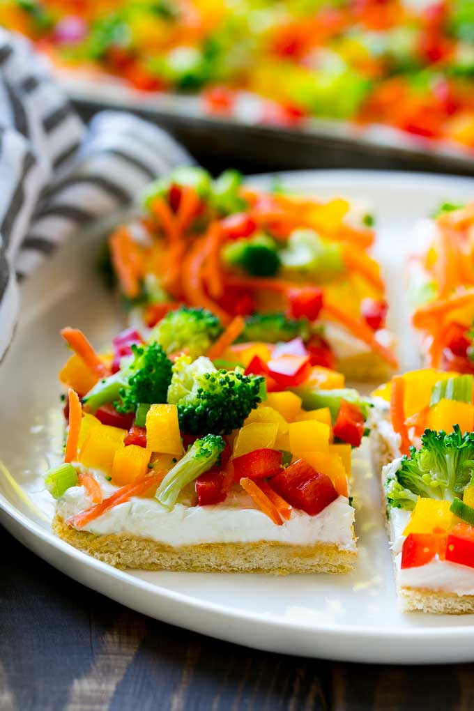 Veggie Pizza Recipe | Crescent Veggie Pizza | Vegetable Pizza Recipe | Holiday Appetizer | Homemade Veggie Pizza #pizza #veggies #vegetarian #appetizer #dinneratthezoo Slices of veggie pizza on a serving plate.