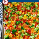 This veggie pizza is a crispy crescent roll crust topped with ranch flavored cream cheese and crunchy colorful vegetables.