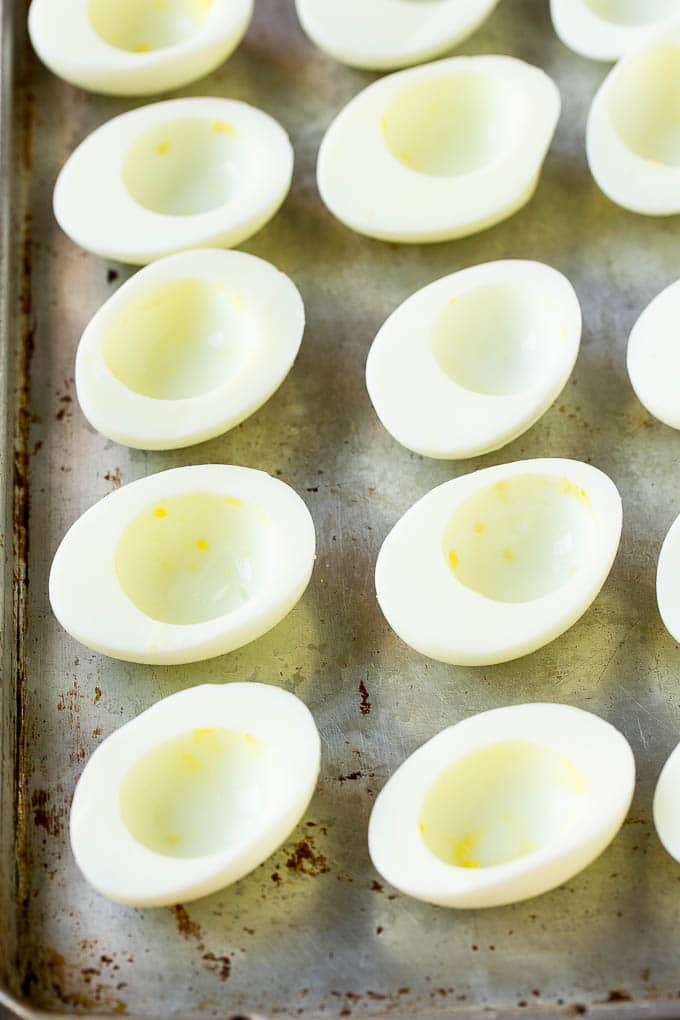 Egg white halves on a sheet pan.