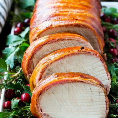 This bacon wrapped pork loin roast is brushed with a sweet and savory glaze, then covered in bacon and grilled to perfection.