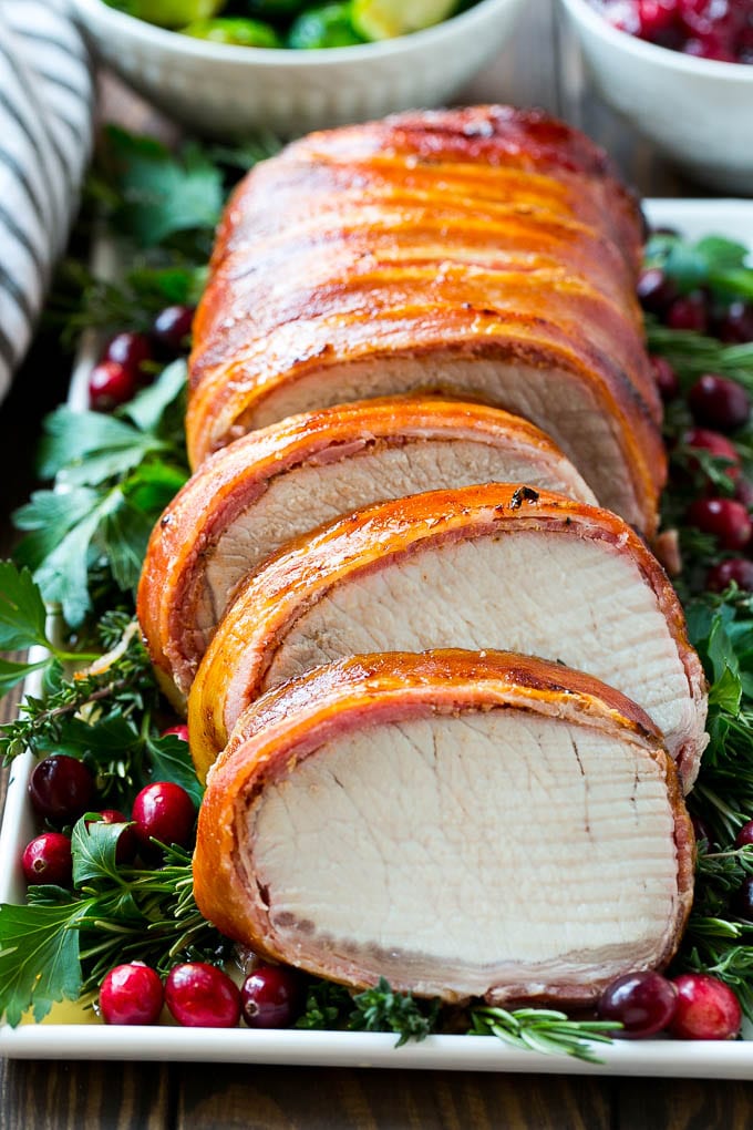 This bacon wrapped pork loin roast is brushed with a sweet and savory glaze, then covered in bacon and grilled to perfection.