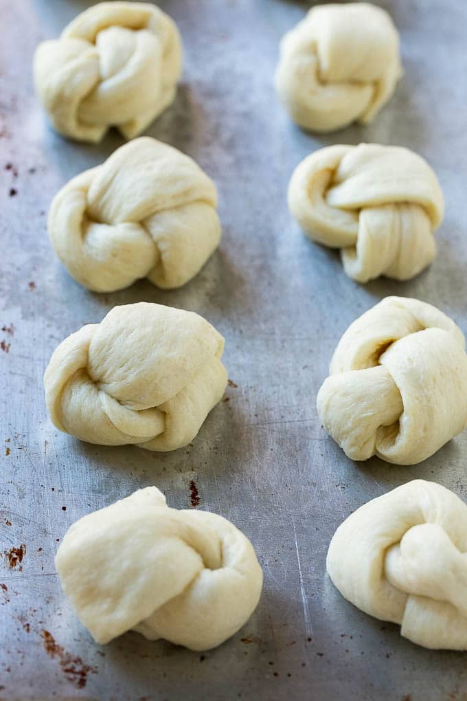 Tie breadstick dough into knots to make these easy garlic rolls.