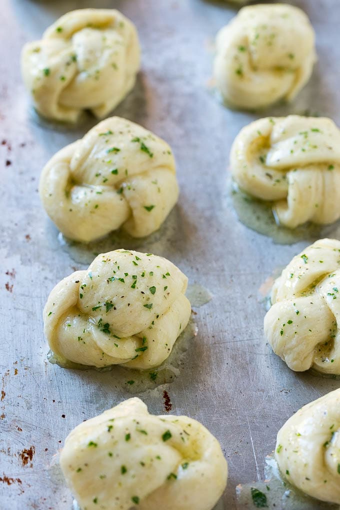 Brush the dough with garlic butter and add herbs and parmesan for extra flavor in these garlic knots.
