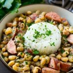 These slow cooker black eyed peas are loaded with ham, sausage and veggies. The perfect crock pot meal to get your new year off to the right start!