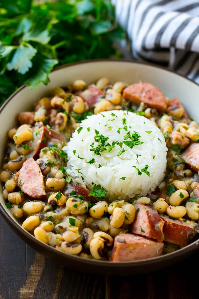 A bowl of slow cooker black eyed peas with a scoop of rice. 