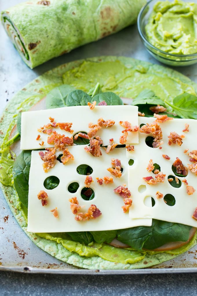 A spinach tortilla layered with turkey, spinach, cheese and bacon.
