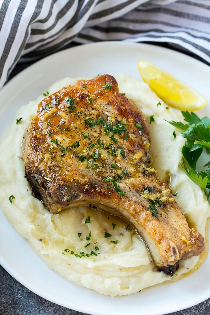 Brown sugar pork chops on a bed of mashed potatoes.