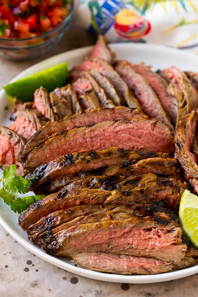 Thinly sliced carne asada steak on a serving plate.