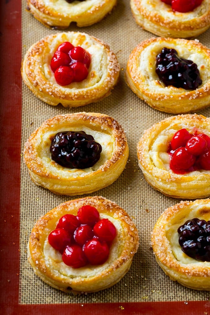 Cream cheese danish topped with cherry and blueberry pie filling.
