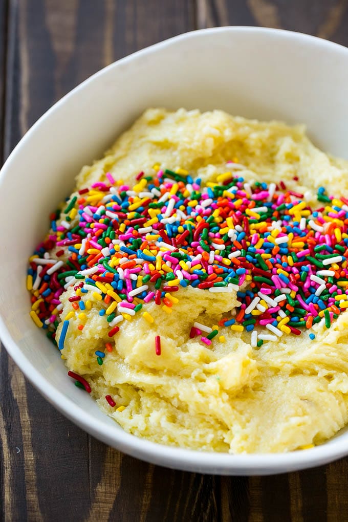 Funfetti Cookies Recipe | Funfetti Cake Mix Cookies | Sprinkle Cookies | Cake Mix Cookies #cookies #funfetti #sprinkles #dessert #dinneratthezoo Cookie dough in a bowl with sprinkles on top.