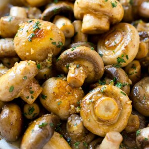 Garlic mushrooms in an herb and butter sauce in a frying pan.
