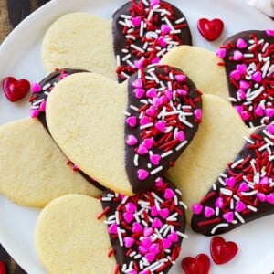 Heart cookies dipped in dark chocolate and decorated with Valentine's Day sprinkles.