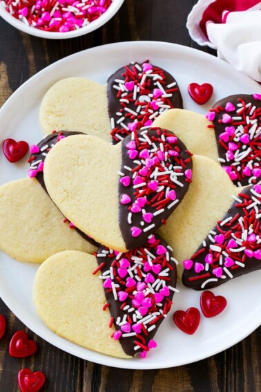 Heart cookies dipped in dark chocolate and decorated with Valentine's Day sprinkles.