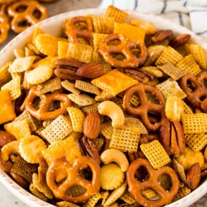 Chex mix in a white serving bowl.