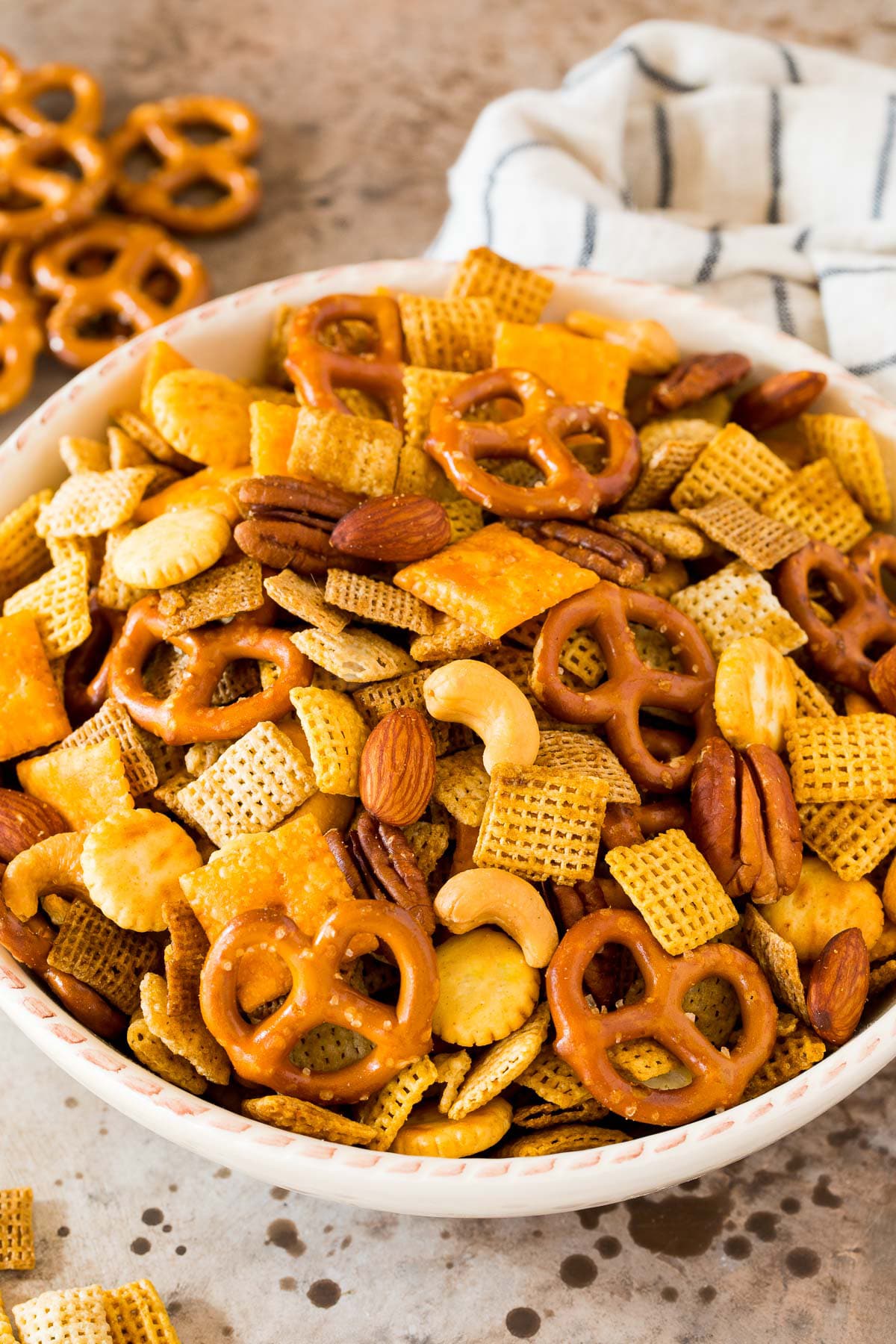 Chex mix in a white serving bowl.