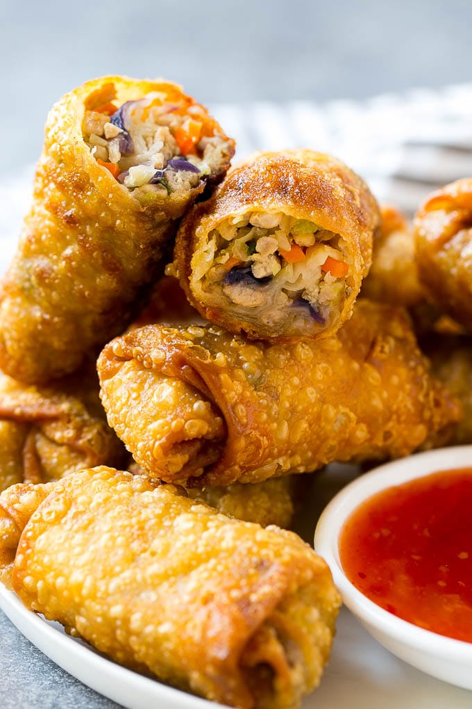 A plate of homemade egg rolls with dipping sauce.