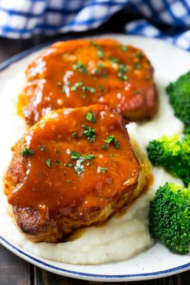 Honey garlic pork chops served over mashed potatoes with a side of broccoli.