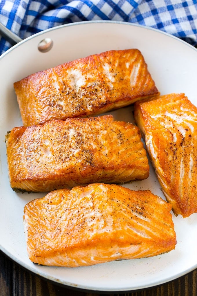 Cooked salmon fillets in a frying pan.