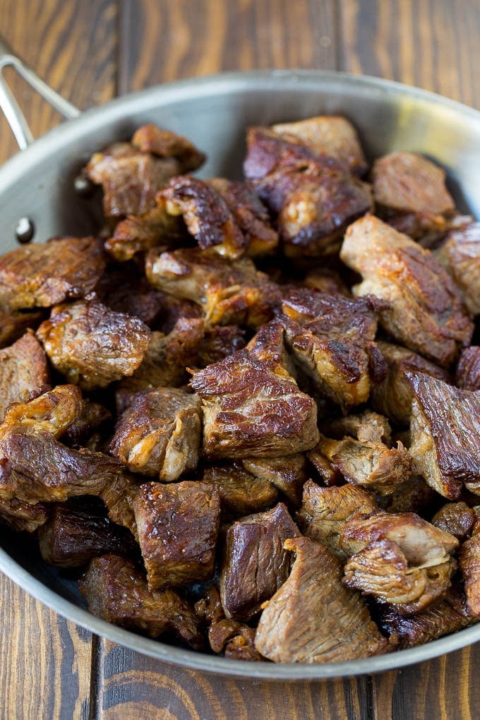 Browned beef in a skillet.