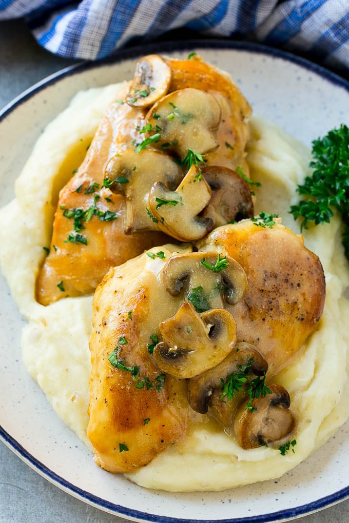 Slow cooker chicken marsala served over mashed potatoes.