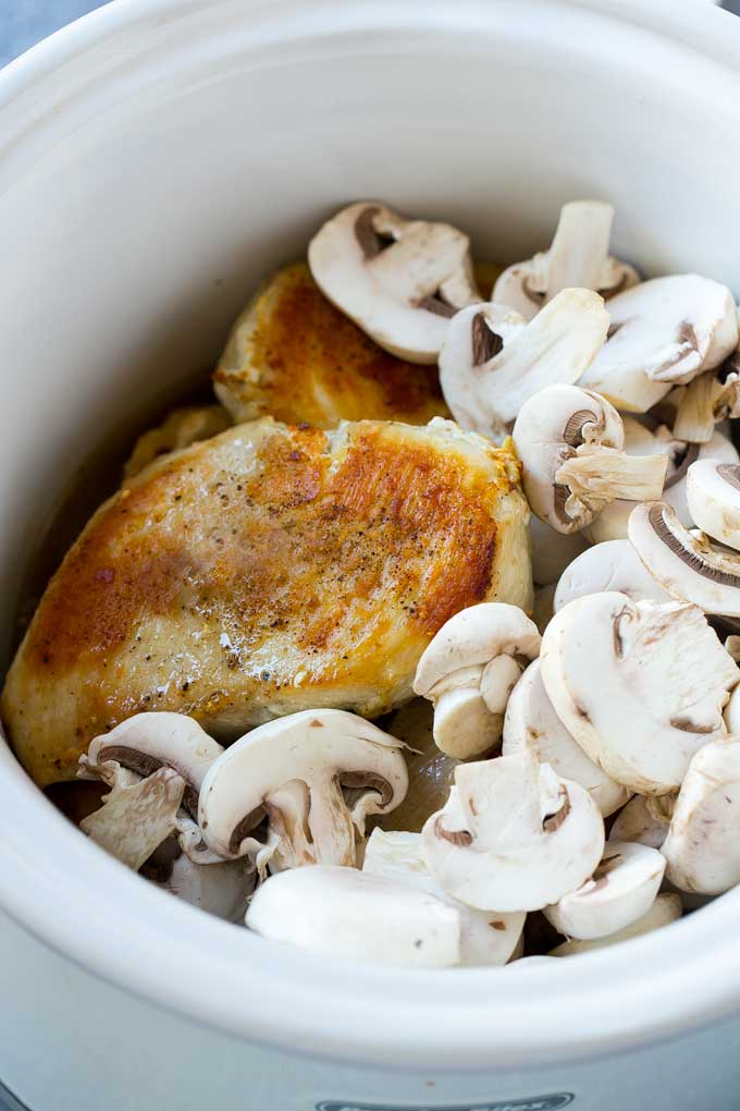 Chicken breasts and mushrooms in a slow cooker are the basis of crock pot chicken marsala.