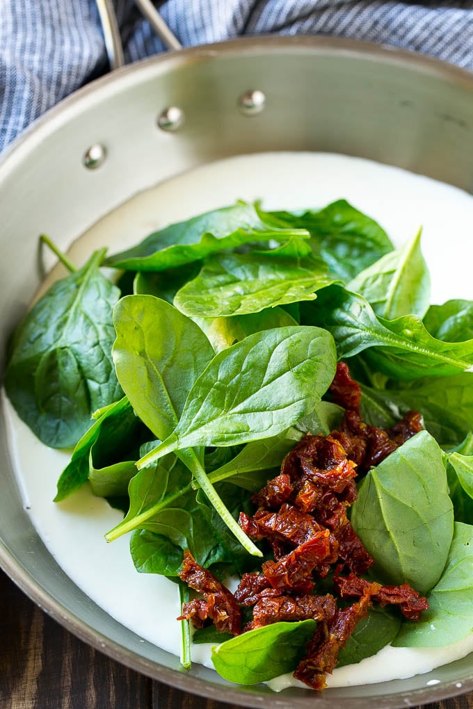 A cream sauce with fresh spinach and sun dried tomatoes.