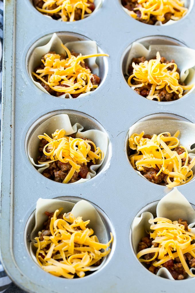 Layers of meat and shredded cheese are combined with wontons then baked.