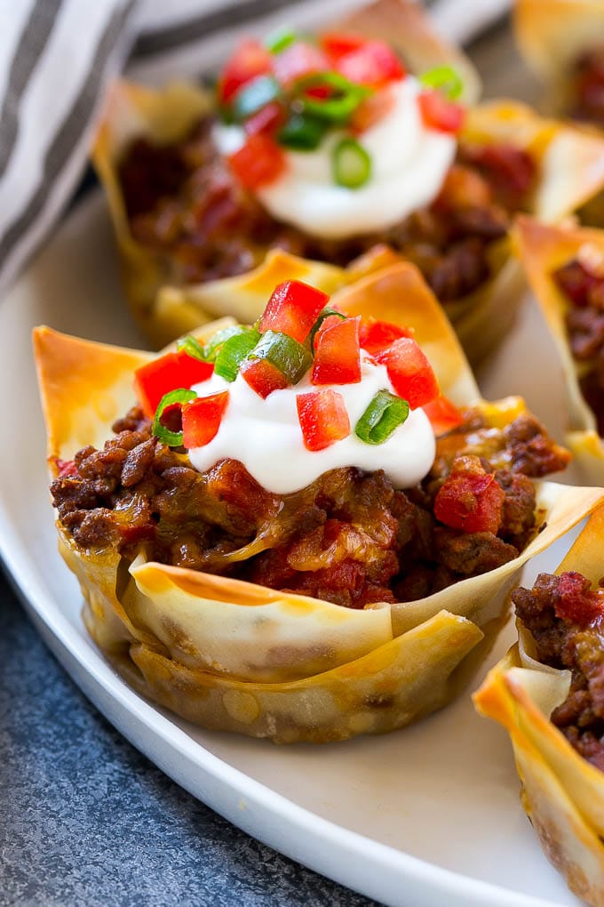 Taco cupcakes layered with wontons, seasoned meat and cheese, then baked to perfection.