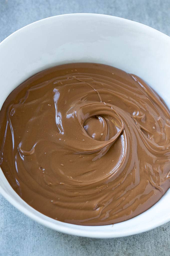 Melted chocolate in a bowl for birds nest cookies.