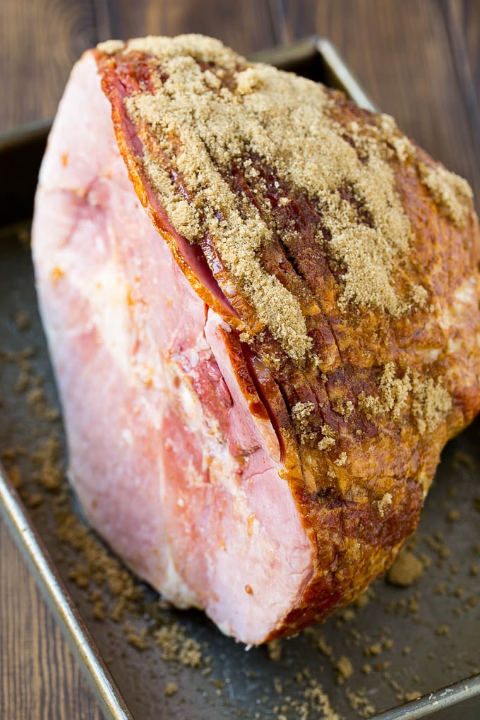 A spiral glazed ham coated in brown sugar.