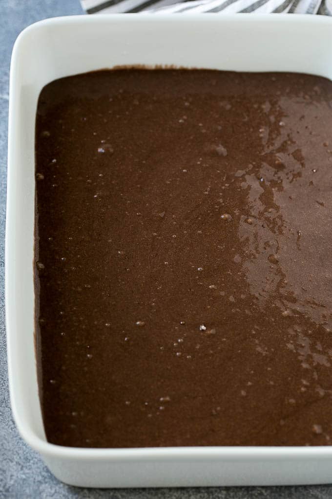 Chocolate cake batter in a baking dish.