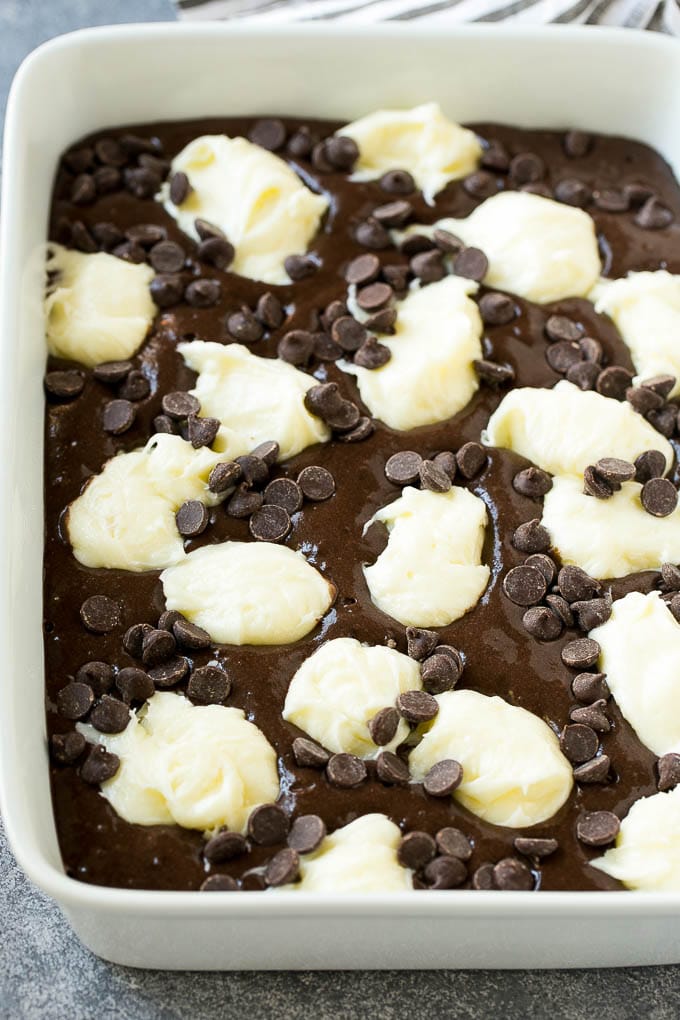 Earthquake Cake Recipe | Chocolate Cake Recipe | Chocolate Coconut Cake | Coconut Pecan Cake #cake #chocolate #coconut #pecans #dessert #chocolatecake #dinneratthezoo Chocolate cake batter topped with dollops of sweetened cream cheese and chocolate chips.