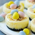 These mini Easter egg cheesecakes have a chocolate cookie crust, creamy cheesecake center and are finished off with a coconut nest and candy Easter eggs.