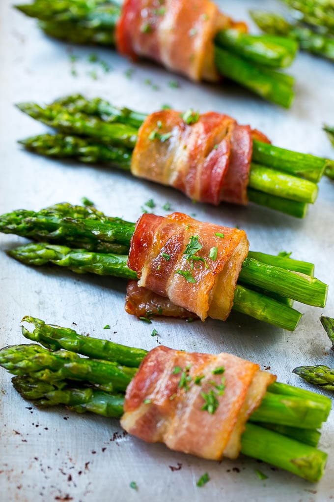 Roasted asparagus in bundles on a sheet pan.