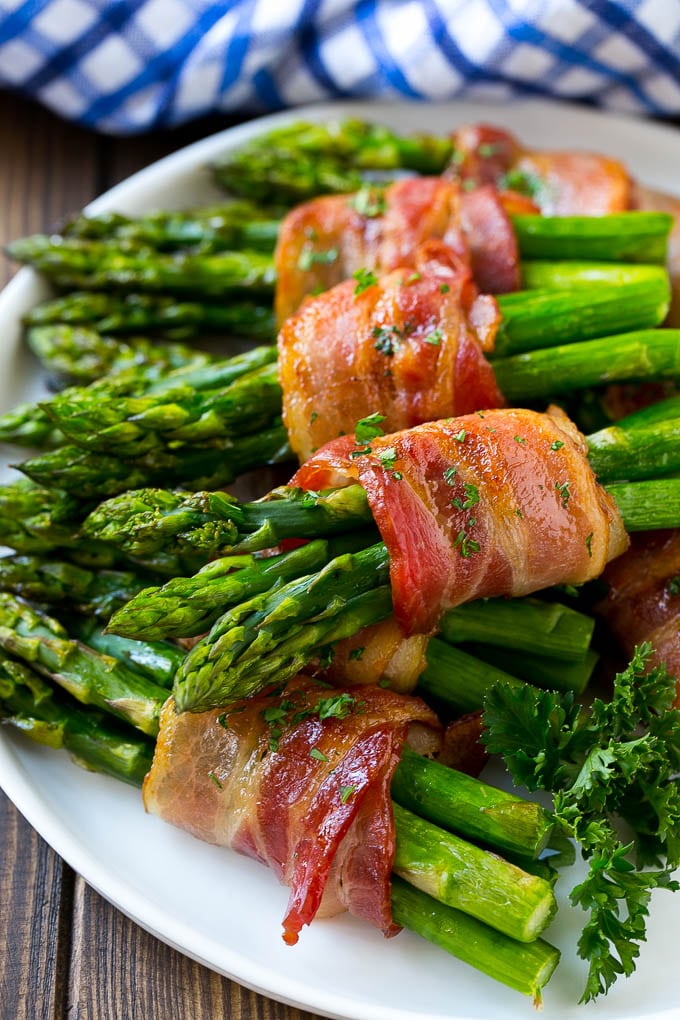 Bacon wrapped asparagus on a serving plate.
