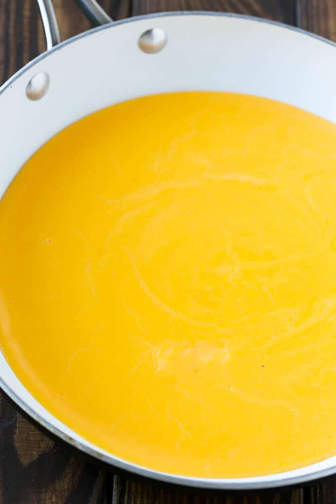 A pan of melted cheese sauce.