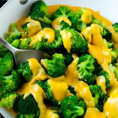 A pan of broccoli with cheese sauce that's full of steamed broccoli florets and homemade sauce.
