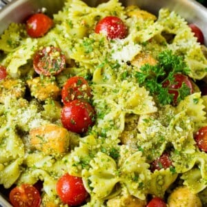 Chicken pesto pasta with cherry tomatoes and parmesan cheese.