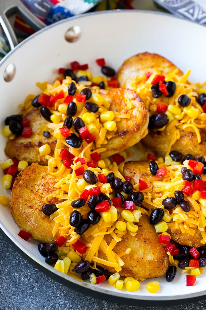 Chicken breasts topped with shredded cheese, black beans, corn and bell peppers.