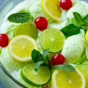 Lime sherbet punch garnished with cherries, lemons, limes and mint.