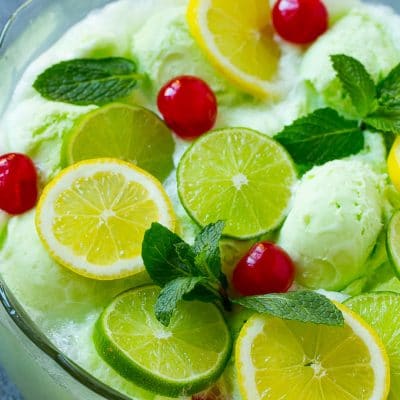 Lime sherbet punch garnished with cherries, lemons, limes and mint.