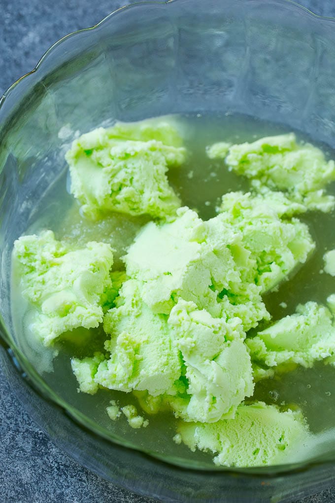 A bowl with limeade concentrate and sherbet in it.