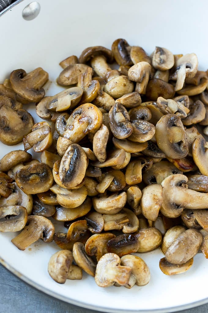 A pan of sauteed mushrooms form the base of mushroom sauce for pork chops.