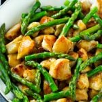 Chicken and asparagus stir fry in a savory brown sauce.