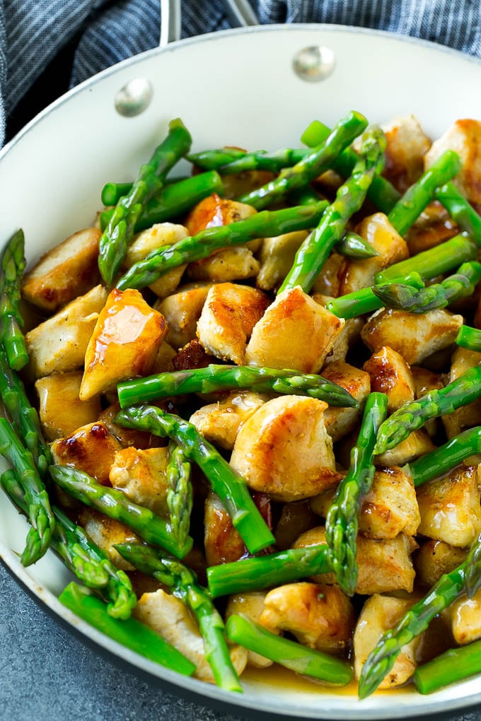 Chicken and asparagus stir fry in a savory brown sauce.